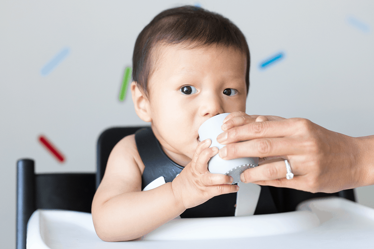 6 month old baby drinking from tiny cup