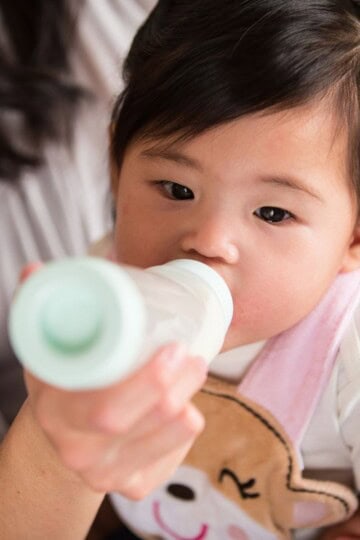 baby drinking from a bottle