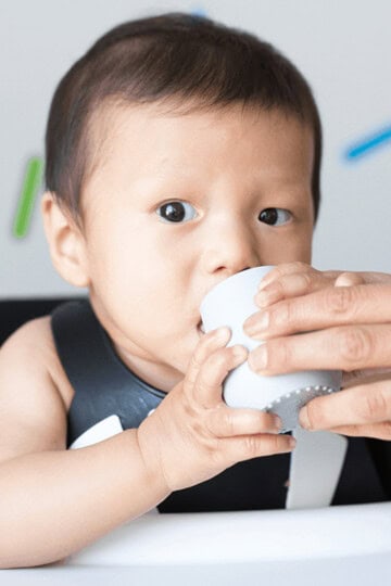 baby drink water from open cup