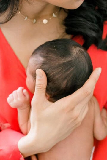 mother holding her baby chest to chest