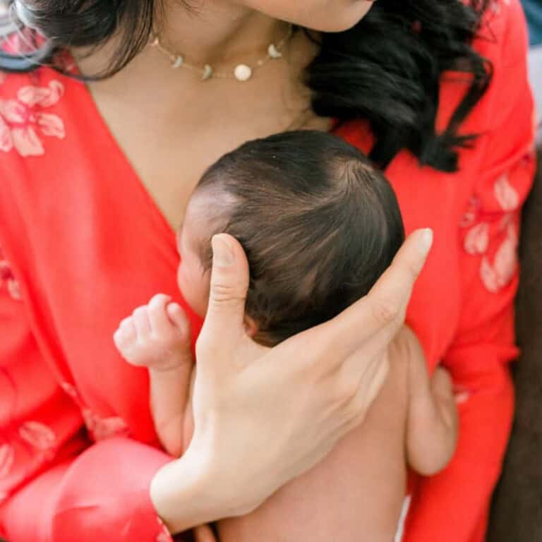 mother holding her baby chest to chest