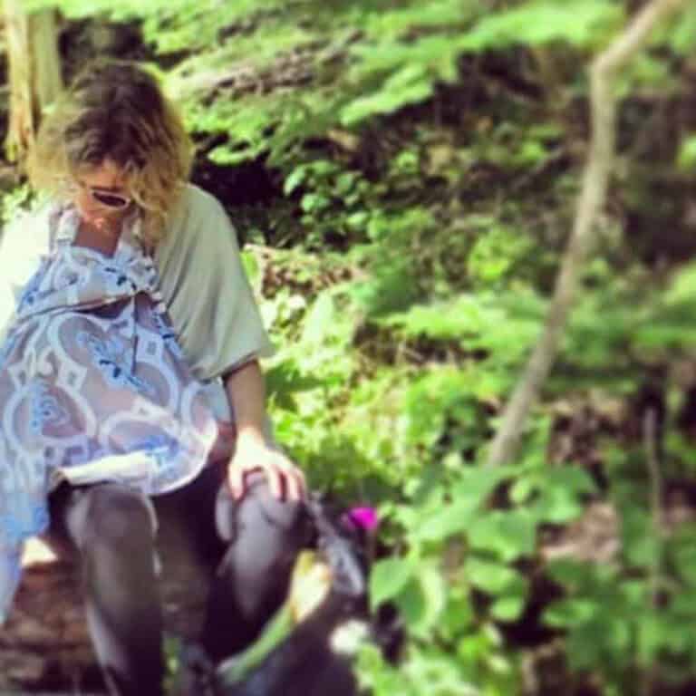 mother breastfeeding with a nursing cover