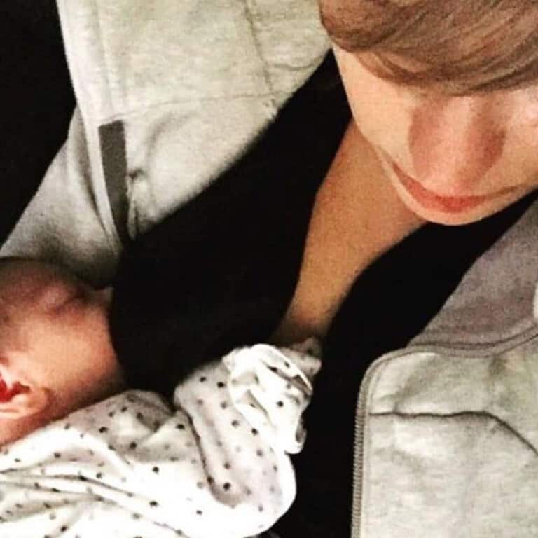 mother breasting her baby and holding him