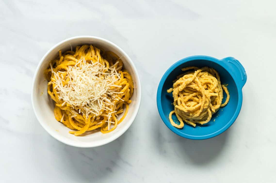 A side by side image of a bowl of creamy pumpkin spaghetti for the family and a bowl with slight adaptations for baby