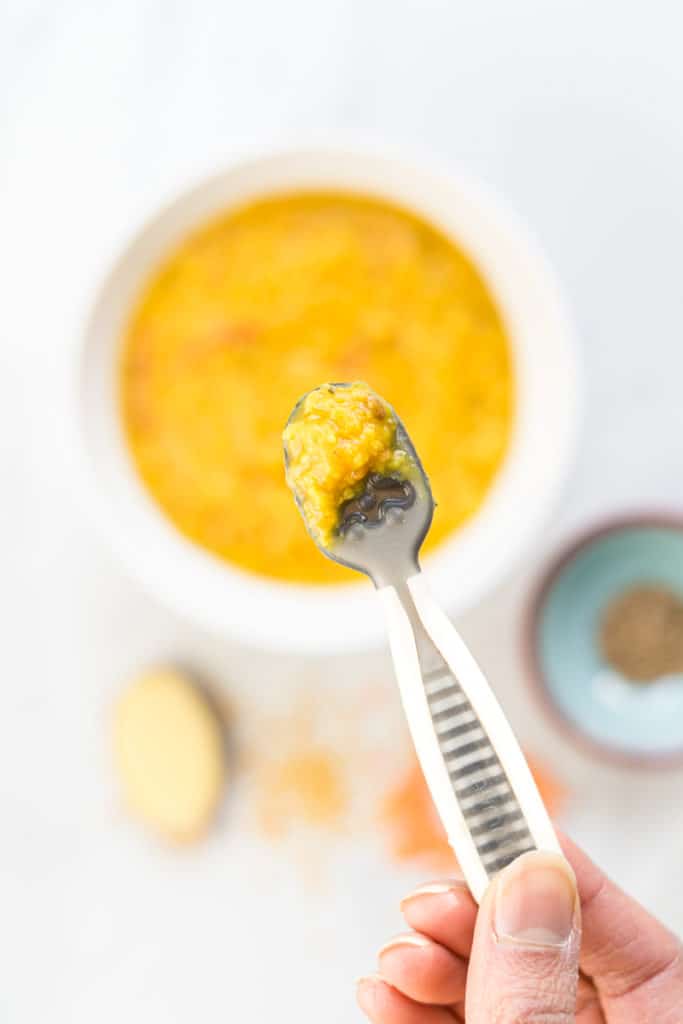 a baby spoon filled with daal, and indian lentil dish, perfect for baby's first food
