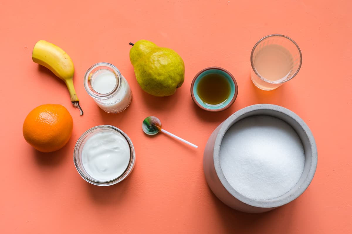 a flatlay image of foods that contain both naturally occurring and refined sources of sugar