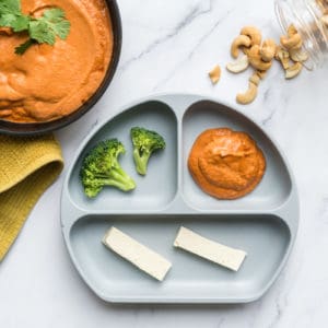 dairy free cashew korma sauce served to a baby with steamed broccoli and tofu