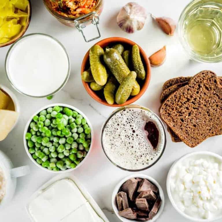 a collage of gut healthy foods like yogurt, kombucha, peas, pickles, fread, kimchi, sauerkraut.