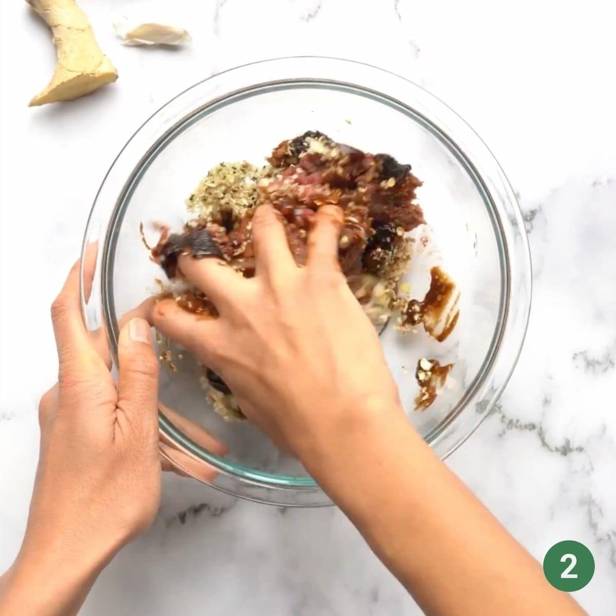 Mixing by hand the ingredients for baby prune burgers.