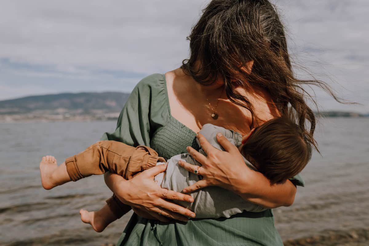 Sarah-Anne Gusdal breastfeeding her son on the beach
