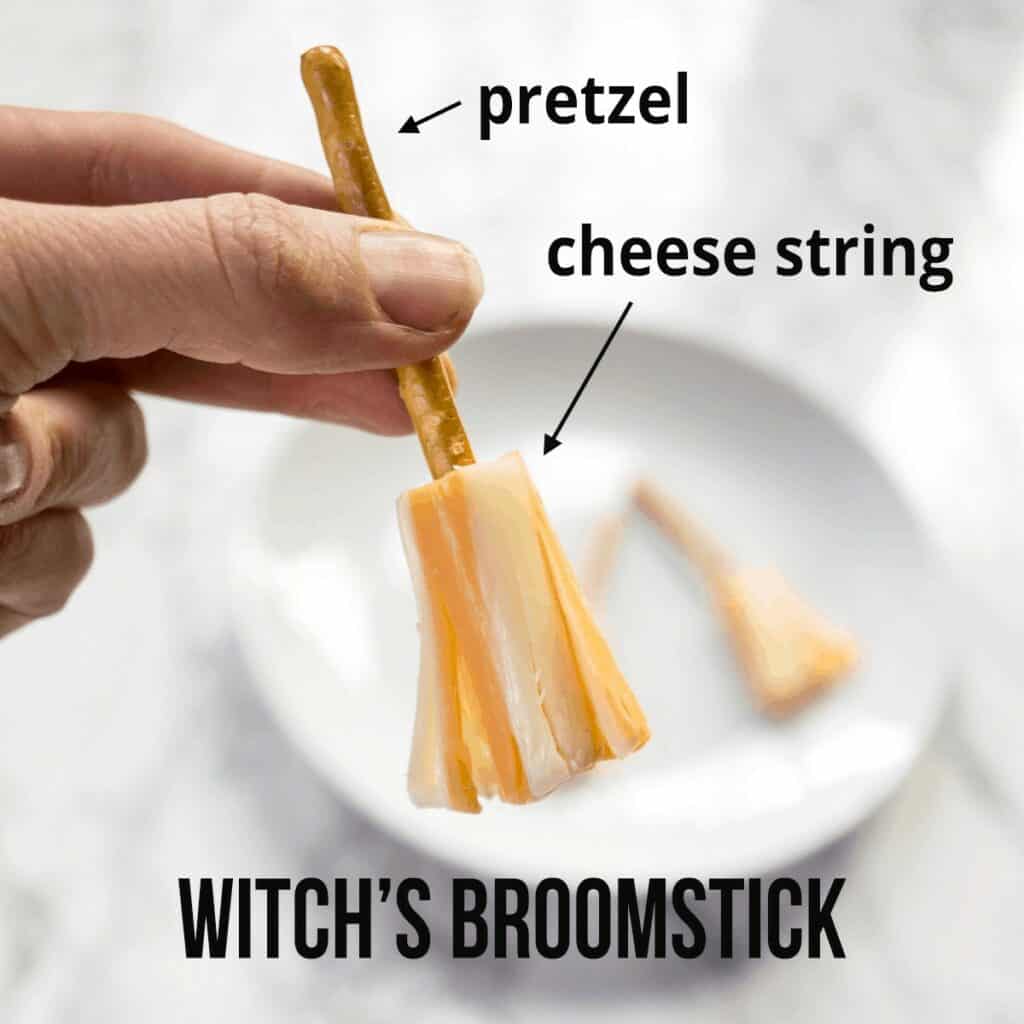 Half a cheese string, pulled to look like the straw on a broom, with a pretzel for a broom stick.