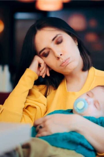 tired mom holding baby