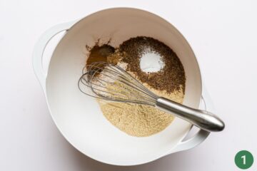 Dry ingredients in a mixing bowl for homemade baby teething biscuits.