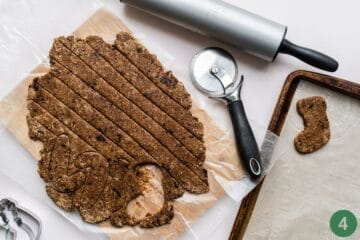 The dough for the homemade baby teething cookies is now rolled out. You can either cut into strips using a pizza roller or use cookie cutters. 