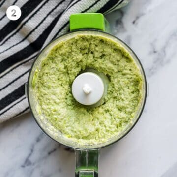 Food processor with creamy and blended edamame puree.