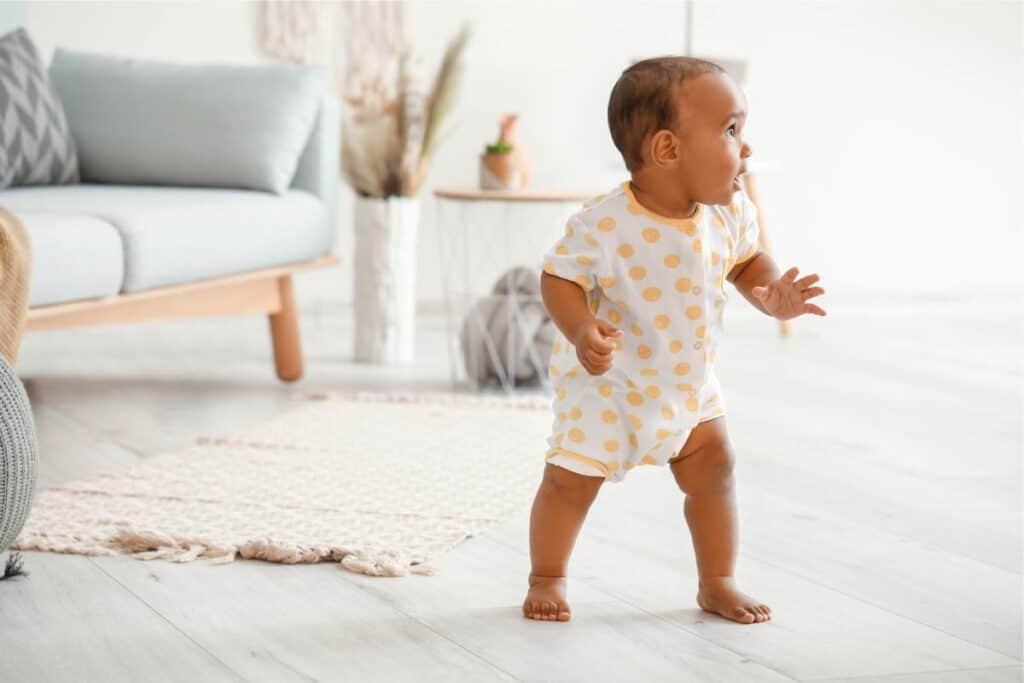 baby with brown skin learning to walk