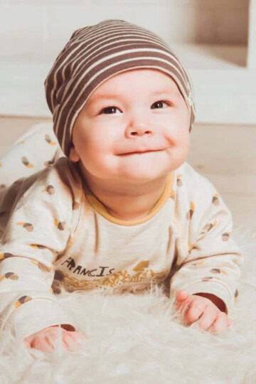 Baby lying on tummy propped up on elbows.