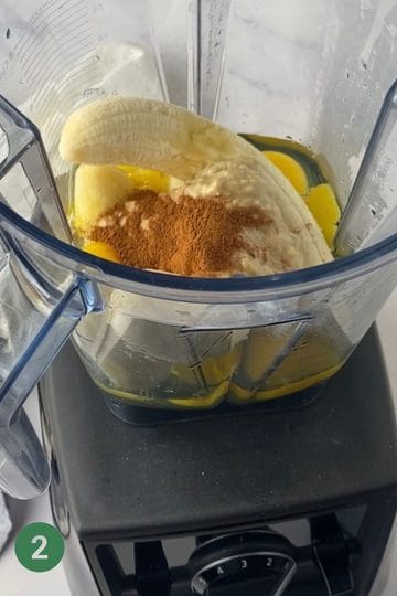 Image of a blender with wet ingredients for banana porridge fingers: eggs, banana, tahini and cinnamon.