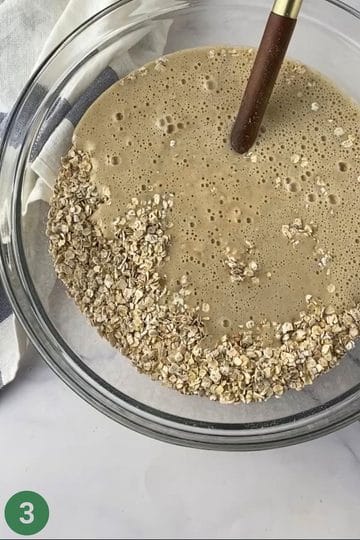 Large bowl of dry ingredients and wet ingredients about to be mixed for banana porridge fingers.