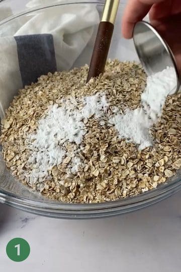 Large bowl with oats and baking powder for banana porridge fingers.