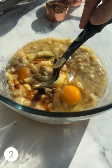 mashed banana, eggs, butter and vanilla a bowl being mixed 