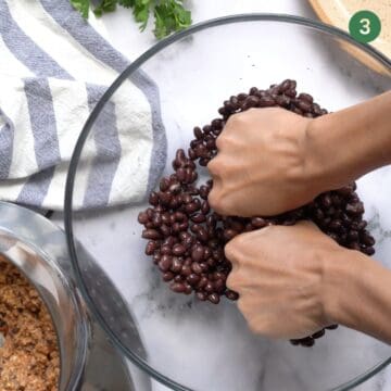 mashing black beans up with hands. 