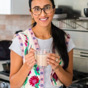 Nita holding a mug of masala chai
