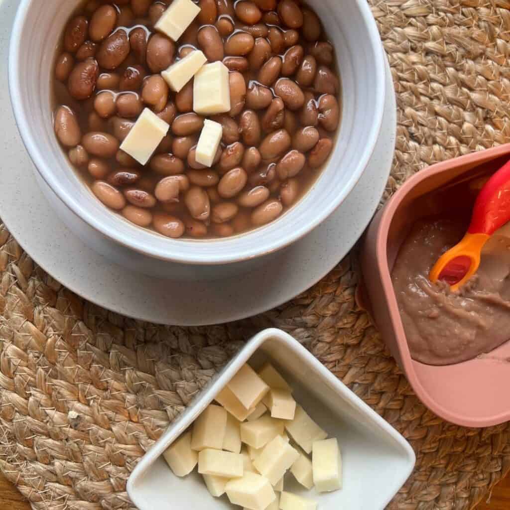 A bowl of Mexican beans for Mamá and a bowl of blended Mexican beans for babies.