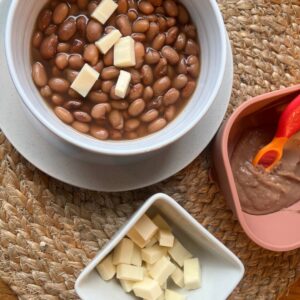 A bowl of Mexican beans for Mamá and a bowl of blended Mexican beans for babies.