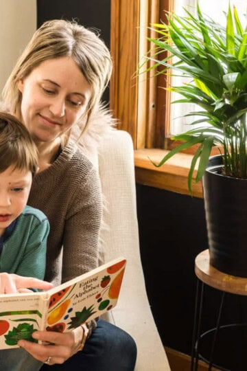 Mom reading book to toddler.