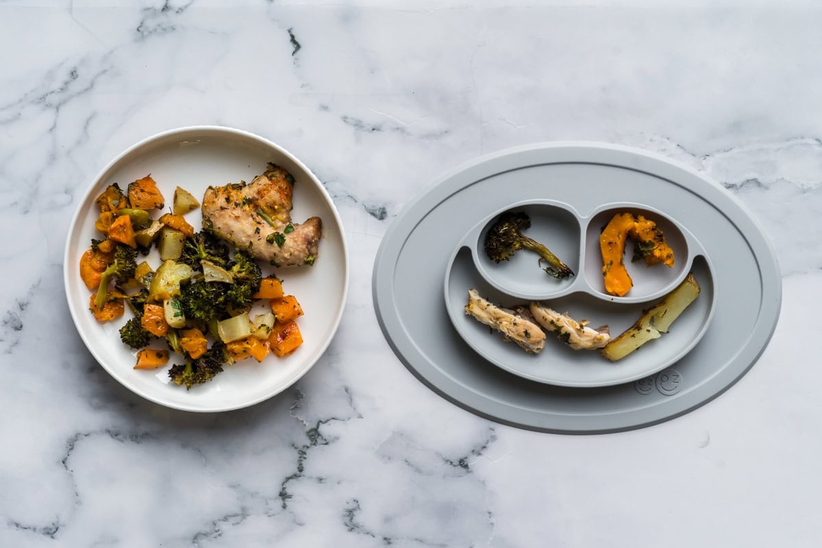 An adult plate of one pan herbed lemon chicken alongside a baby plate with the same meal adapted to be baby friendly.