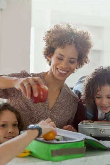 Mom packing lunches with her two daughters.