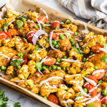 Indian spiced sheet pan chicken drizzled with yogurt