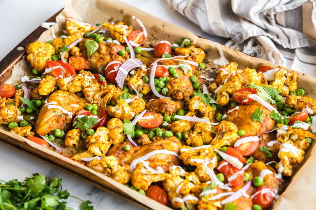 Indian spiced sheet pan chicken drizzled with yogurt