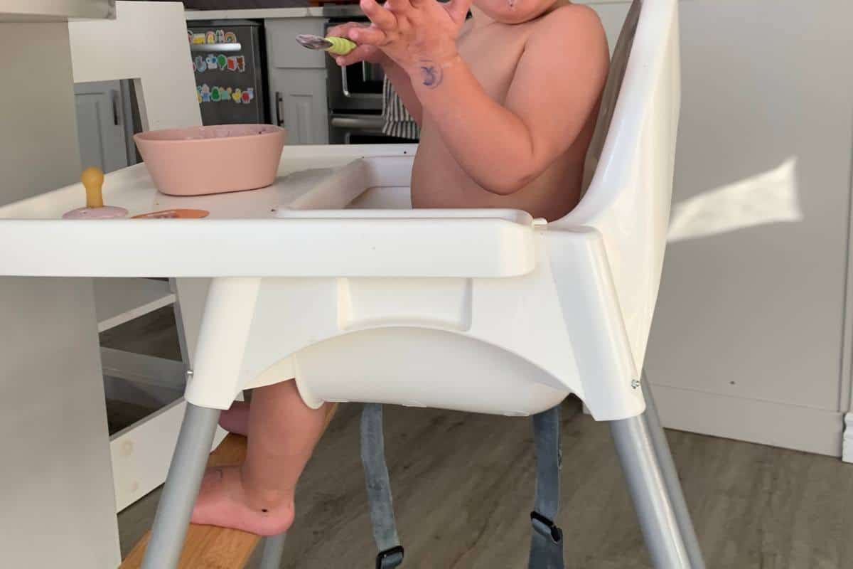 This image highlights baby high chair ergonomics with a foot rest.