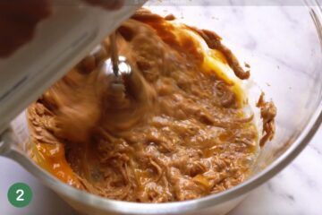 Mixing together the dough ingredients for healthy oat bars made with peanut butter and berries