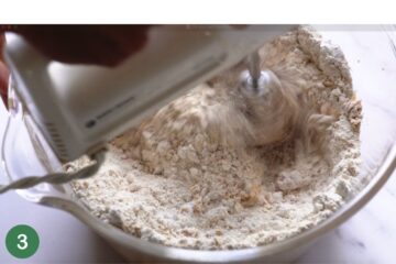 adding in the wet ingredients for healthy oat bars made with peanut butter and berries