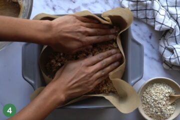 Pressing the dough into the pan for healthy breakfast bar recipe for toddlers.