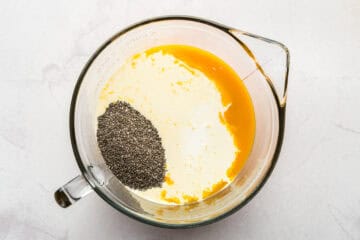 Ingredients for mango chia popsicles in a mixing bowl.