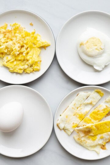 Flat lay of eggs and different variations for a baby. Clockwise, there is scrambled egg, poached egg, fried egg strips and hardboiled egg.