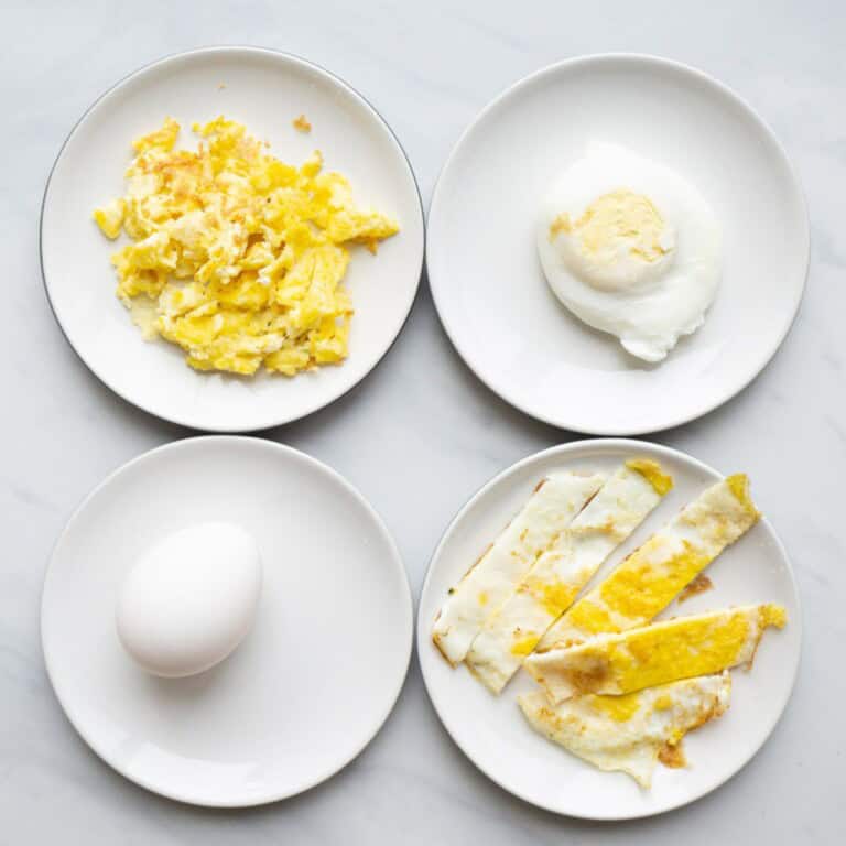 Flat lay of eggs and different variations for a baby. Clockwise, there is scrambled egg, poached egg, fried egg strips and hardboiled egg.