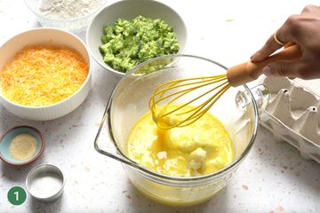 Bowl with eggs and mashed potato being whisked together.