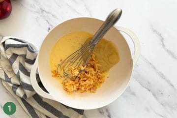 Mixing the wet ingredients in a large bowl to make healthy applesauce cake.